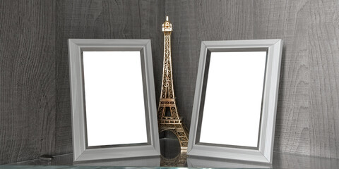 Two blank wooden photo frames stands on glass shelf in living room