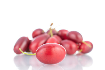 Several bright red ripe dogwood berries, close-up, isolated on white.