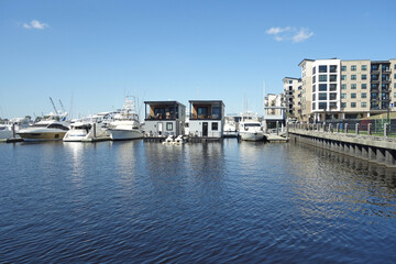 The riverwalk along the Cape Fear River in downtown Wilmington NC, with a marina, houseboats and apartments