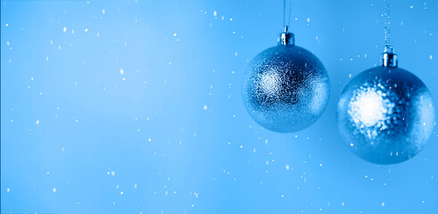 Fototapeta na wymiar Christmas balls on a blue snowy background.