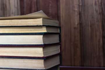 Heap of old old hardback books. Close-up of a stack of old used books