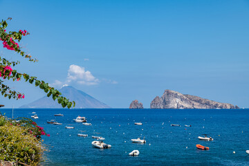 Panarea island (Aeolian archipelago), Lipari, Messina, Sicily, Italy, 08.21.2021: view of Stromboli and Basiluzzo islands. - obrazy, fototapety, plakaty