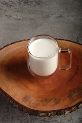 cup of milk on wooden table