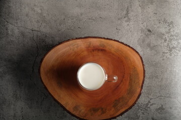 top angle of a glass of milk on the wooden table