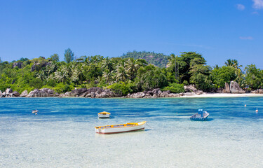Boat on the shore of a tropical island. Pleasure boat moored on the shore of the resort. Beautiful...