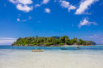 Boat on the shore of a tropical island. Pleasure boat moored on the shore of the resort. Beautiful tropical landscape of the Seychelles.