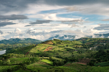 Fototapeta na wymiar Landscape of rural agricultural hill with sunlight shine in rainy season at Khao Kho