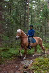 Man  horseback riding in forest