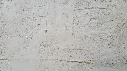 The plastered wall is gray. The wall inside the room. Background picture with scratches. Architecture and construction. Interior design. Copy space for text.