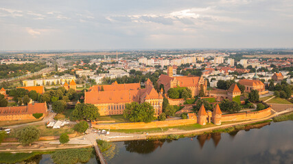 Malbork,Poland. Aerial photo from drone to Medieval Malbork ( Zamek w Maborku, Ordensburg Marienburg ),castle in Poland fortress of the Teutonic Knights at the Nogat river in sunset light.(Series
