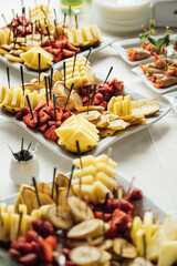 Sandwiches, canapes and cakes on the festive table. A wide variety of snacks