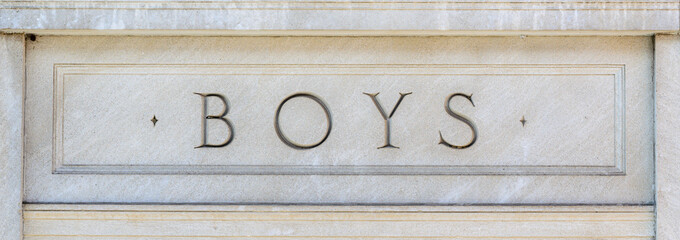 Close-up of a historical Boys School entrance sign in Canada