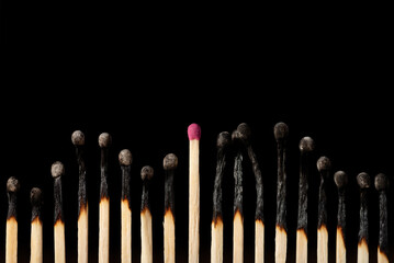 Chain of matches, burned from the top, one good matchstick stands in the middle. Concept of...