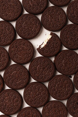 Round chocolate chip cookies with cream filling solid background