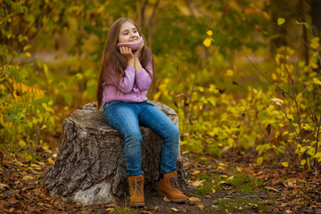 Naklejka na ściany i meble autumn outdoor portrait of beautiful happy child girl