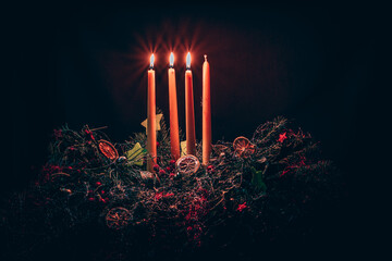 three burning candles on advent wreath