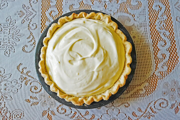 Lemon Chiffon Pie - A top down view of a lemon chiffon pie against a lace tablecloth
