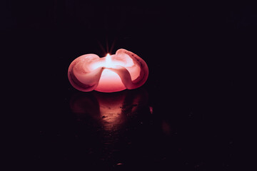 burning candle on black background, copy space