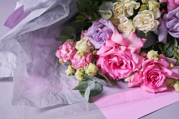 Close-up of a colorful bouquet of flowers. Big pink roses. On a light background, top view, copy space. High quality photo