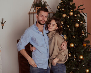 Christmas Couple.Happy Smiling Family at home celebrating.New Year People