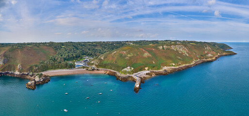 Panoramic aerial drone view of Bouley Bay and adjacent coast line in the sunshine. Jersey, Channel Islands