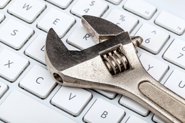 An Adjustable Wrench on a Laptop Keyboard