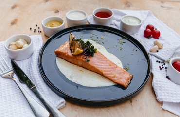 Trout on a plate with cream sauce on a plate