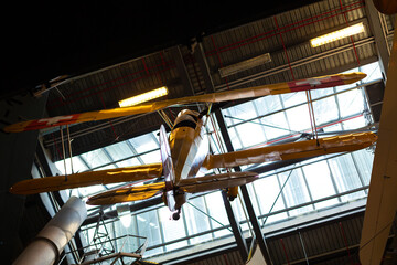 An airplane suspended from the ceiling in the Aircraft Museum