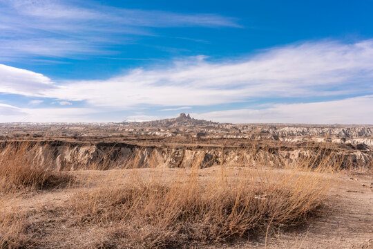 Turkey, Cappadocia, Goreme, Rocky landscape with Uchisar Castle in distance