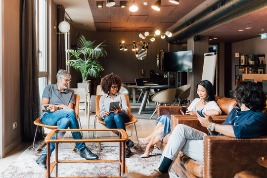 Italy, Business people having meeting in creative studio