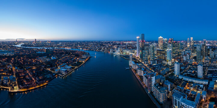 UK, London, Aerial view of Canary Wharf and Thames river at night