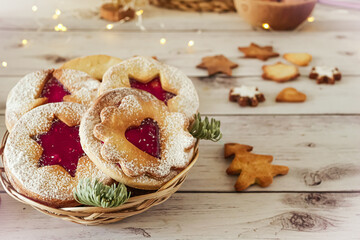 Obraz na płótnie Canvas Delicious homemade Christmas cookies with jam, copy space. Traditional Linzer cookies on a dark table, copy space
