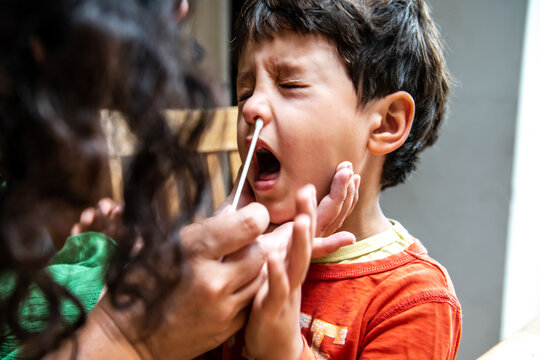UK, Mother and son  using Covid-19 self testing kit at home