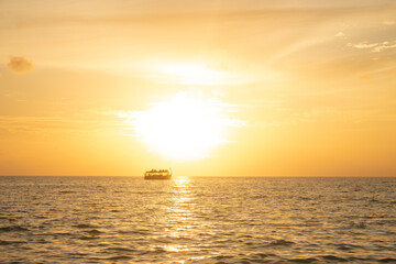 sunset in maldives island with a boat