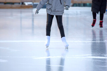 people ice skating on an ice rink. hobbies and leisure. winter sports