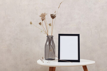 Empty picture frame on the table . Minimalist style home interior decoration. Simple and elegant design. Copy space image.