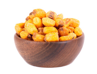 Roasted salted corn nuts in wooden bowl, isolated on white background. Beer snack, dry corn with spices.