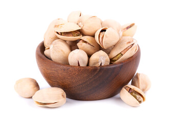 Pistachio nuts, isolated in wooden bowl, on white background. Salted roasted pistachios.