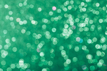 Green glowing sequins blurred background