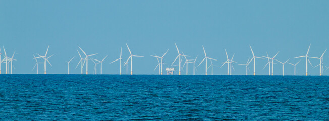 View of the windmills by the sea in a village in Wales