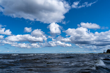 Sea with waves, clouds and bright blue sky