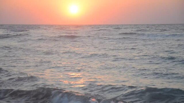 A sunset over a body of water next to the ocean