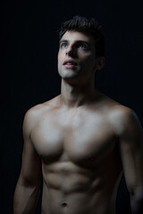 Fototapeta premium Handsome man standing blue eyed, looking up, naked torso.