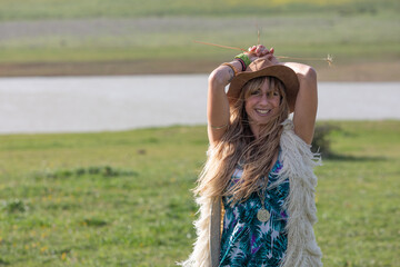 Young blonde boho female beauty on a nature background