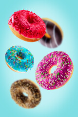 Fototapeta na wymiar Sweet multicolor donuts on a blue background