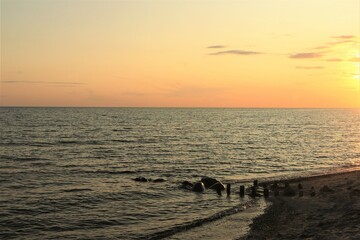Golden sunset on the coast with calm sea, seascape wallpaper, seaside texture