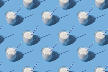 World Milk Day. Pattern on a blue background. A glass of milk with a straw. Sample. Package.