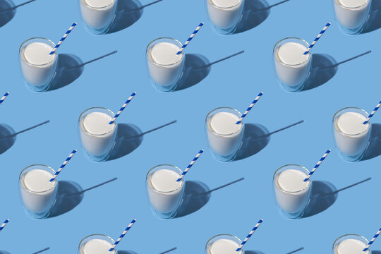 World Milk Day. Pattern on a blue background. A glass of milk with a straw. Sample. Package.