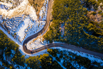 Kopaonik mountain range in Serbia. Aerial view on Kopaonik National Park. Sunset under mountains, hills and meadows. Winding road along the mountains