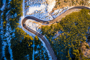 Kopaonik mountain range in Serbia. Aerial view on Kopaonik National Park. Sunset under mountains, hills and meadows. Winding road along the mountains